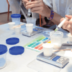 Participant mixing Jesmonite colours using syringes and colour palette at Artzei Studio keycap workshop