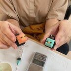 Participant holding two finished bird character keycaps made at Artzei Studio keycap workshop Singapore