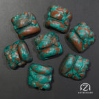 Chomper artisan keycaps in Copper Patina finish laid out on dark background, top-down view
