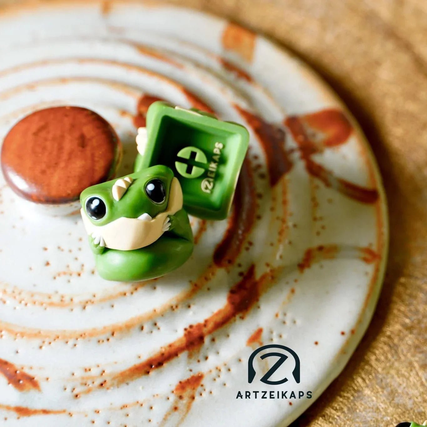 Chomper GMK Cream Matcha artisan keycap in matcha green, front and back view on rustic ceramic plate