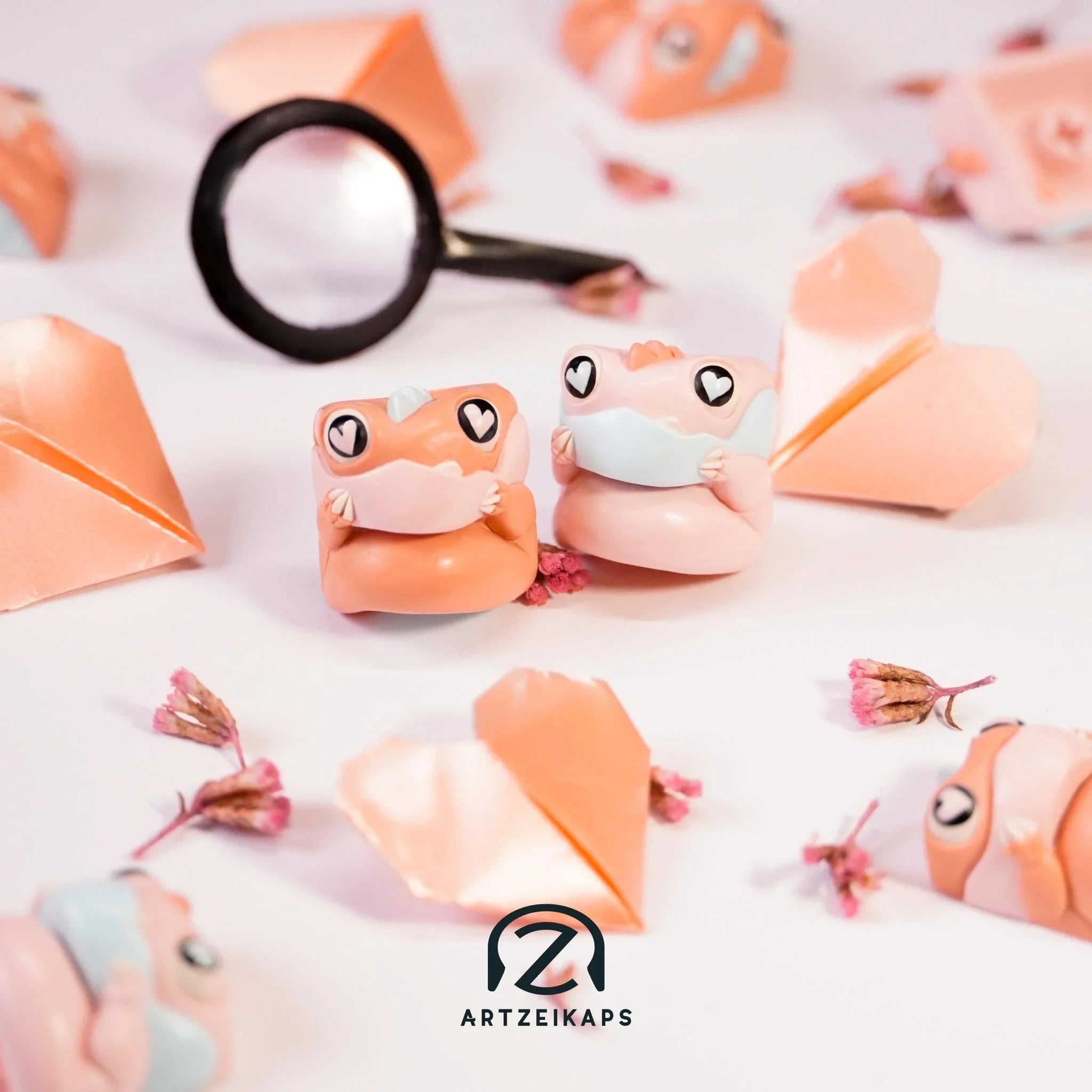 Chomper KBM Love Detective artisan keycap in peach pink with magnifying glass, front and back view surrounded by origami hearts and cherry blossoms