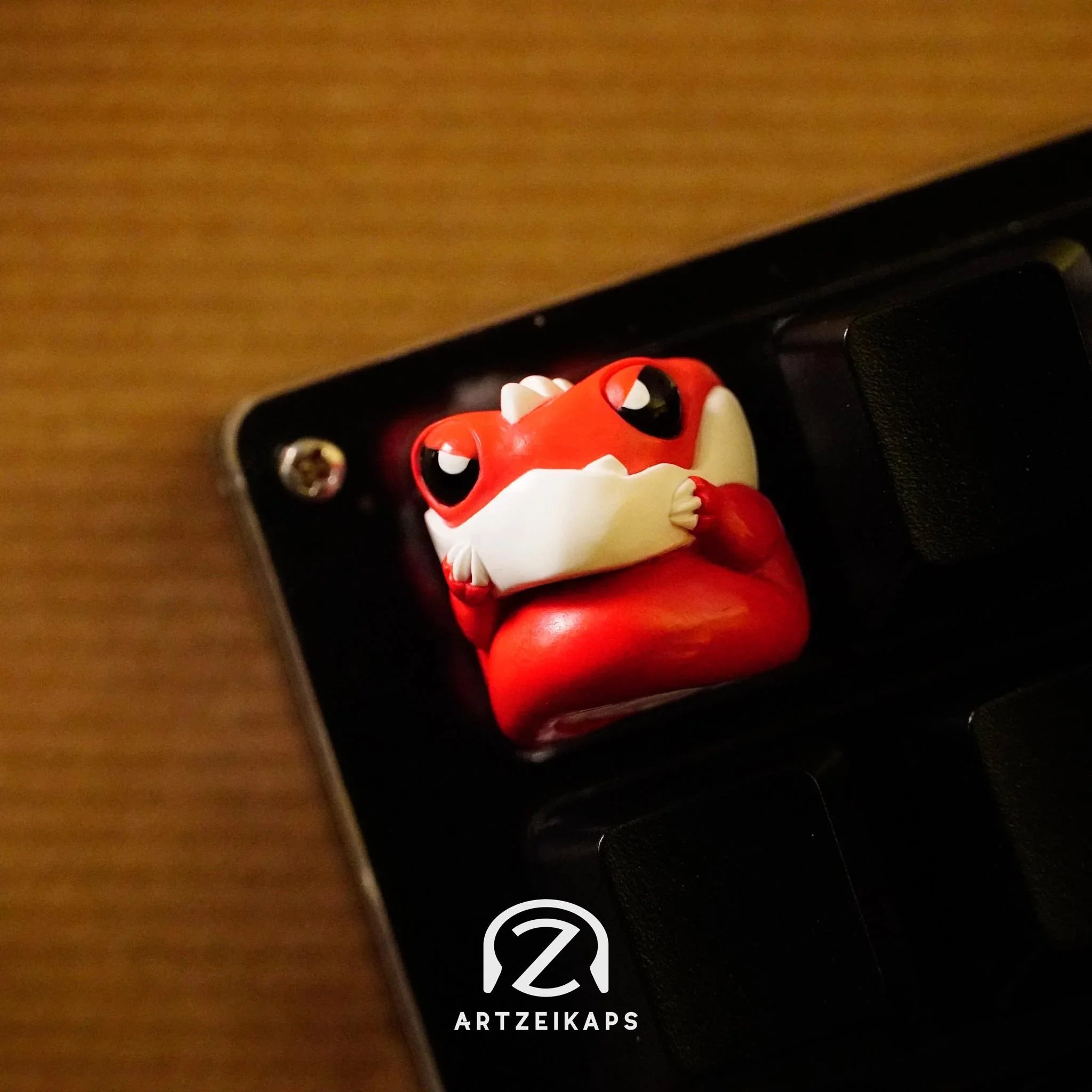 Chomper Lil' Red Grump artisan keycap close-up front view on black mechanical keyboard