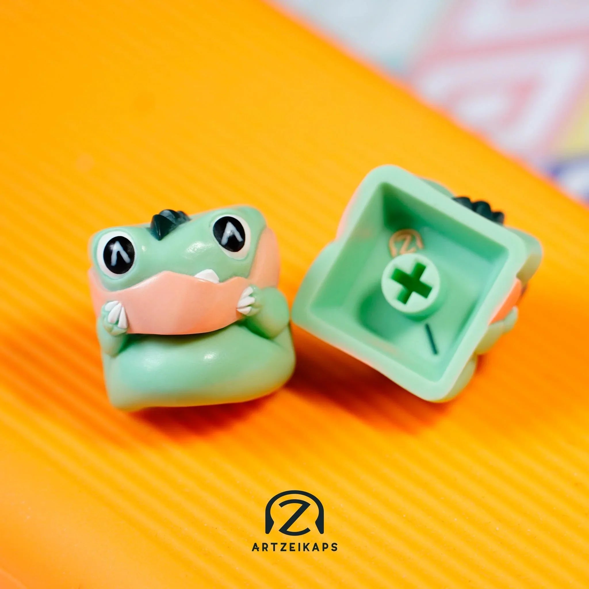 Chomper Minty Peach artisan keycap front and back view on orange background