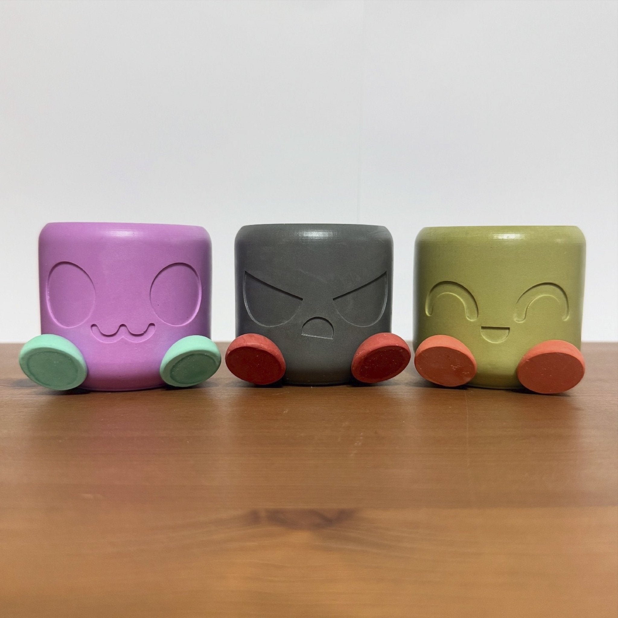 Chonky Pot Mood Edition in purple, grey and olive green with happy face expressions