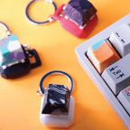 Handmade artisan keycaps on keychains in various colors and marble patterns