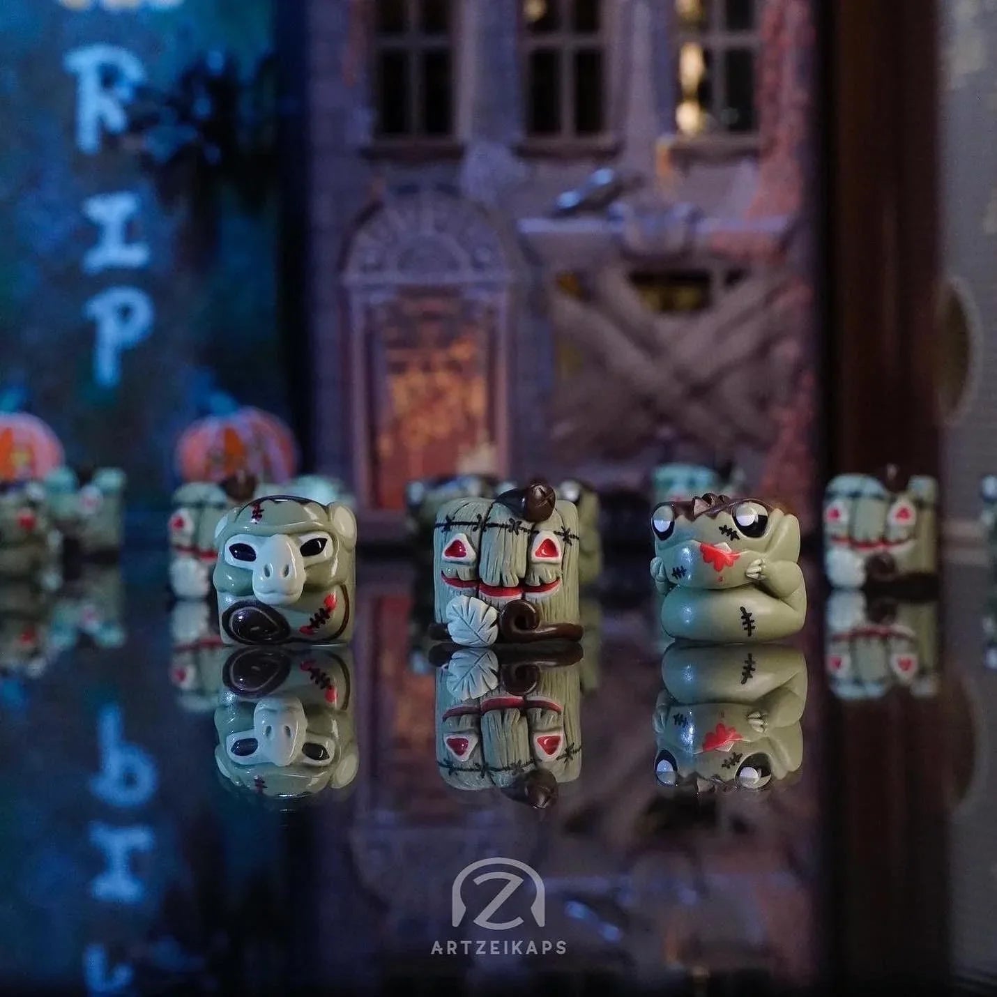 Smunkey, Lil' Huey, Chomper FrankenZ artisan keycaps lined up in a spooky Halloween diorama setting