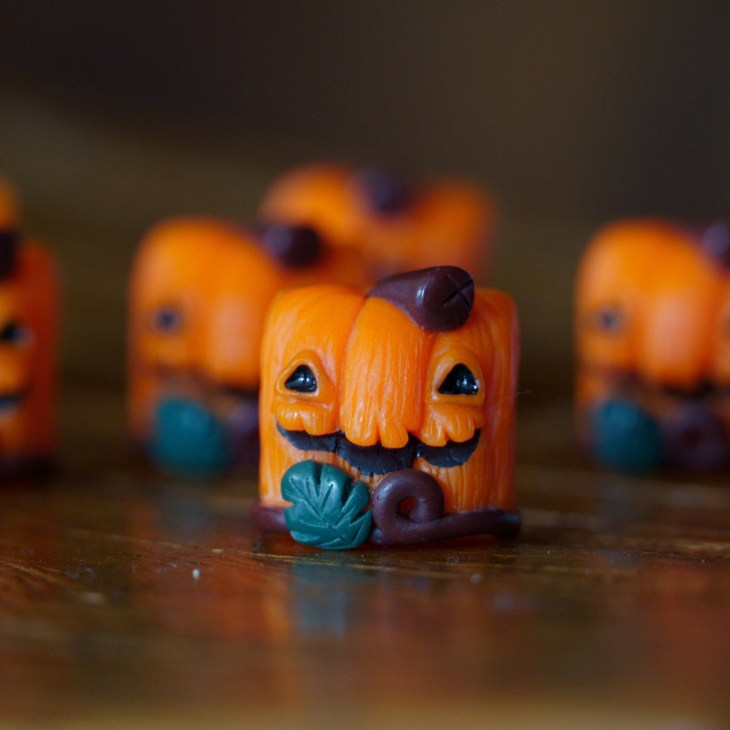 Close up of Lil' Huey OG artisan keycap resin keycap on a brown background