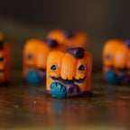 Close up of Lil' Huey OG artisan keycap resin keycap on a brown background