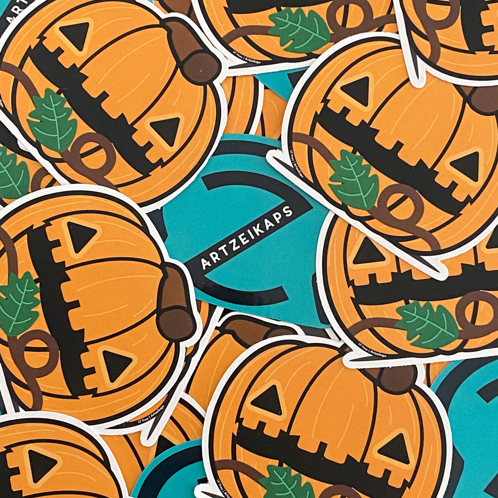 Stickers with pumpkin designs and 'Artzeikaps' branding on a blue background