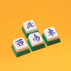 Four Mahjong tiles with blue characters on a yellow background - Mahjong Keycap Workshop Singapore - Corporate Workshops