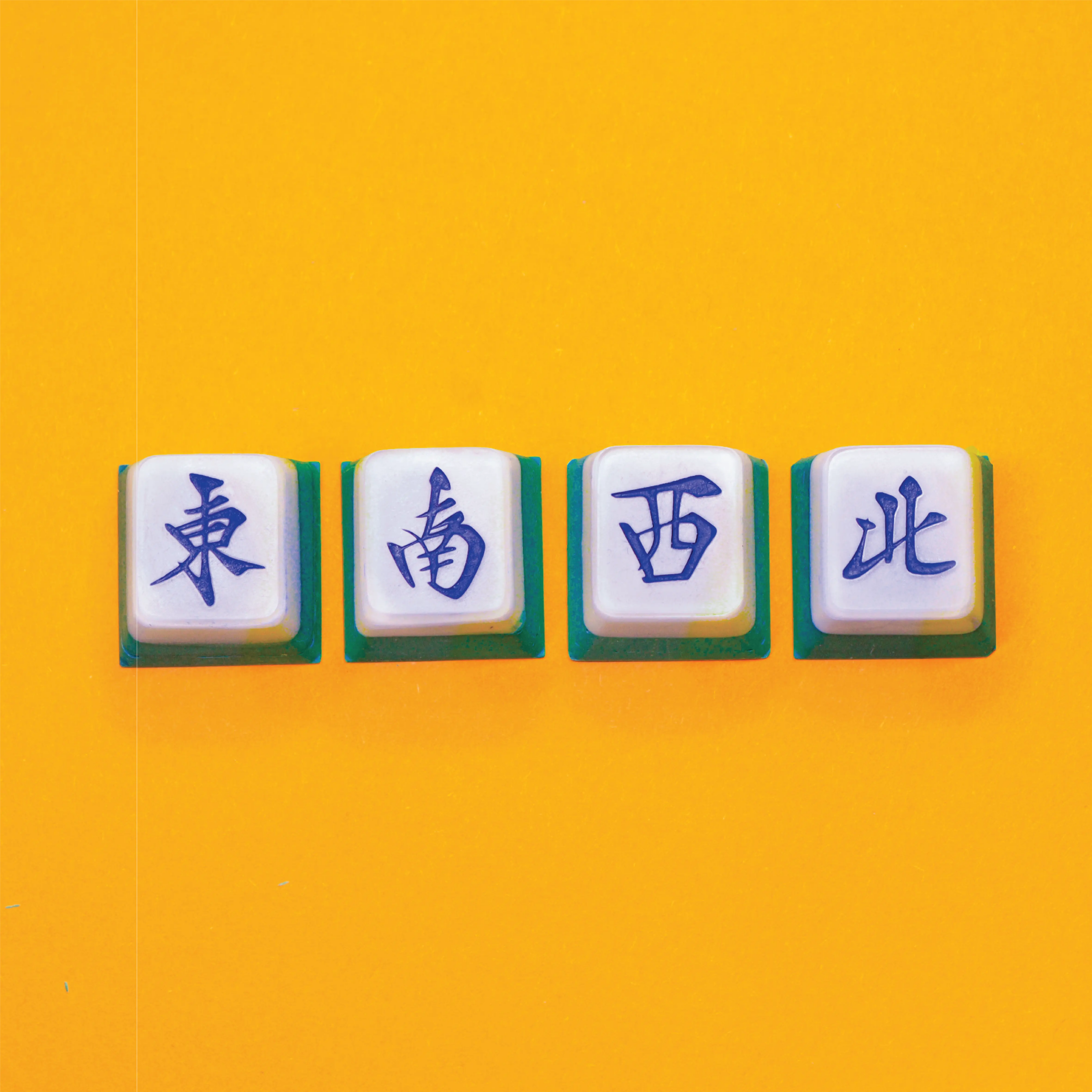 Creative Workshops in Singapore - Mahjong wind tiles artisan keycaps (East, South, West, North) on a bright yellow background. 