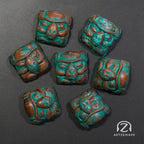 Smunkey artisan keycaps in Copper Patina finish laid out on dark background, top-down view