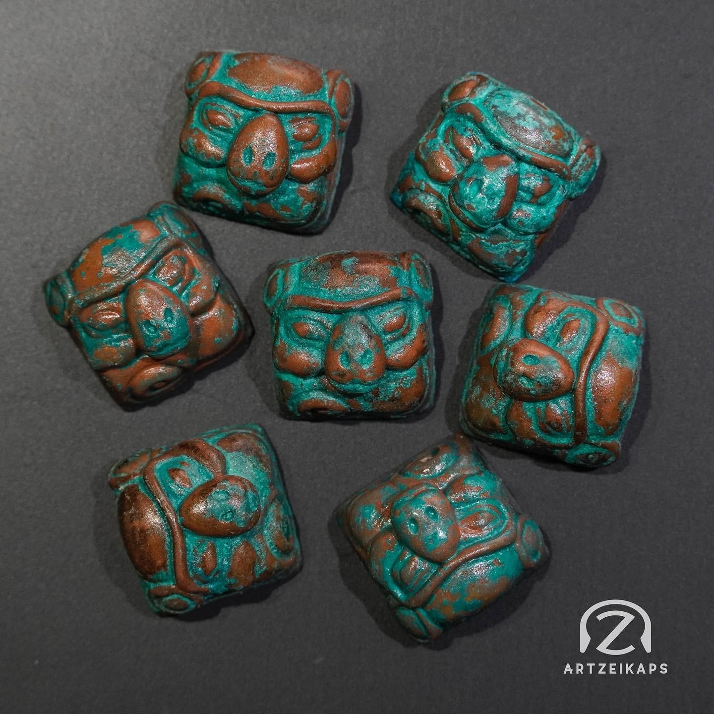 Smunkey artisan keycaps in Copper Patina finish laid out on dark background, top-down view