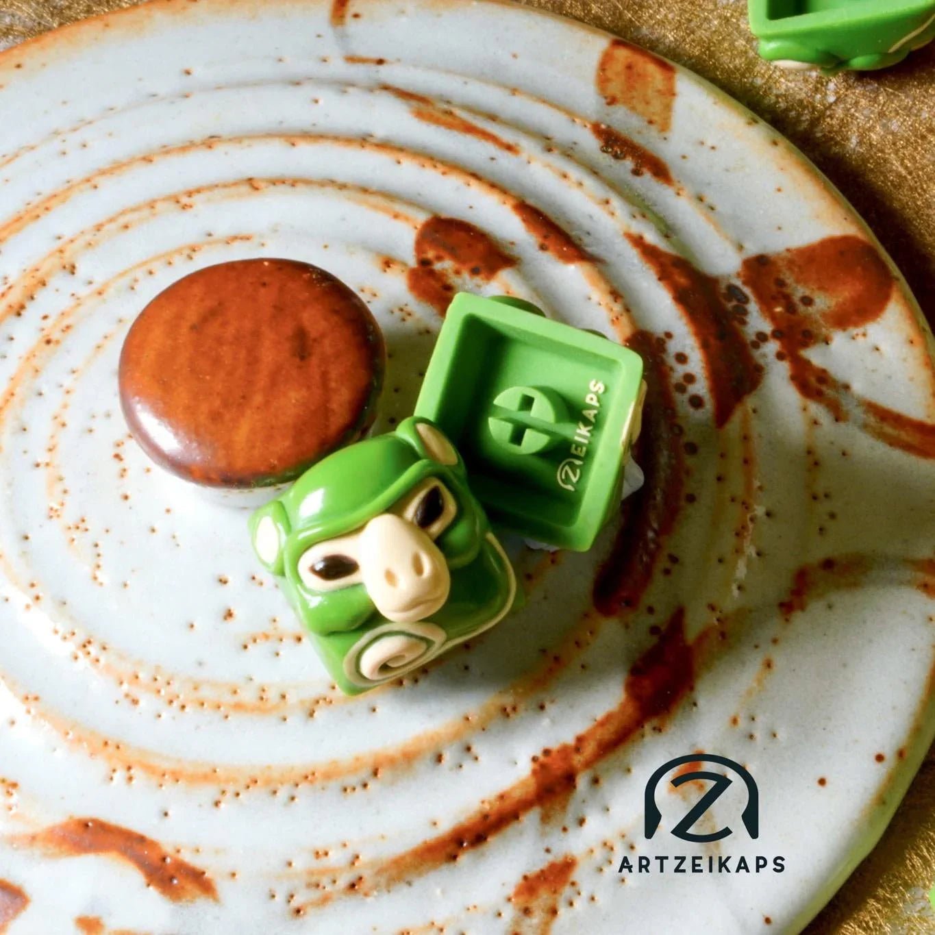 Smunkey GMK Cream Matcha artisan keycap in matcha green, front and back view on rustic ceramic plate