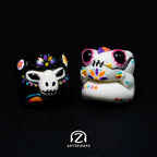 Smunkey and Chomper GMK Mictlan artisan keycap pair showing light and dark colourways on dark background