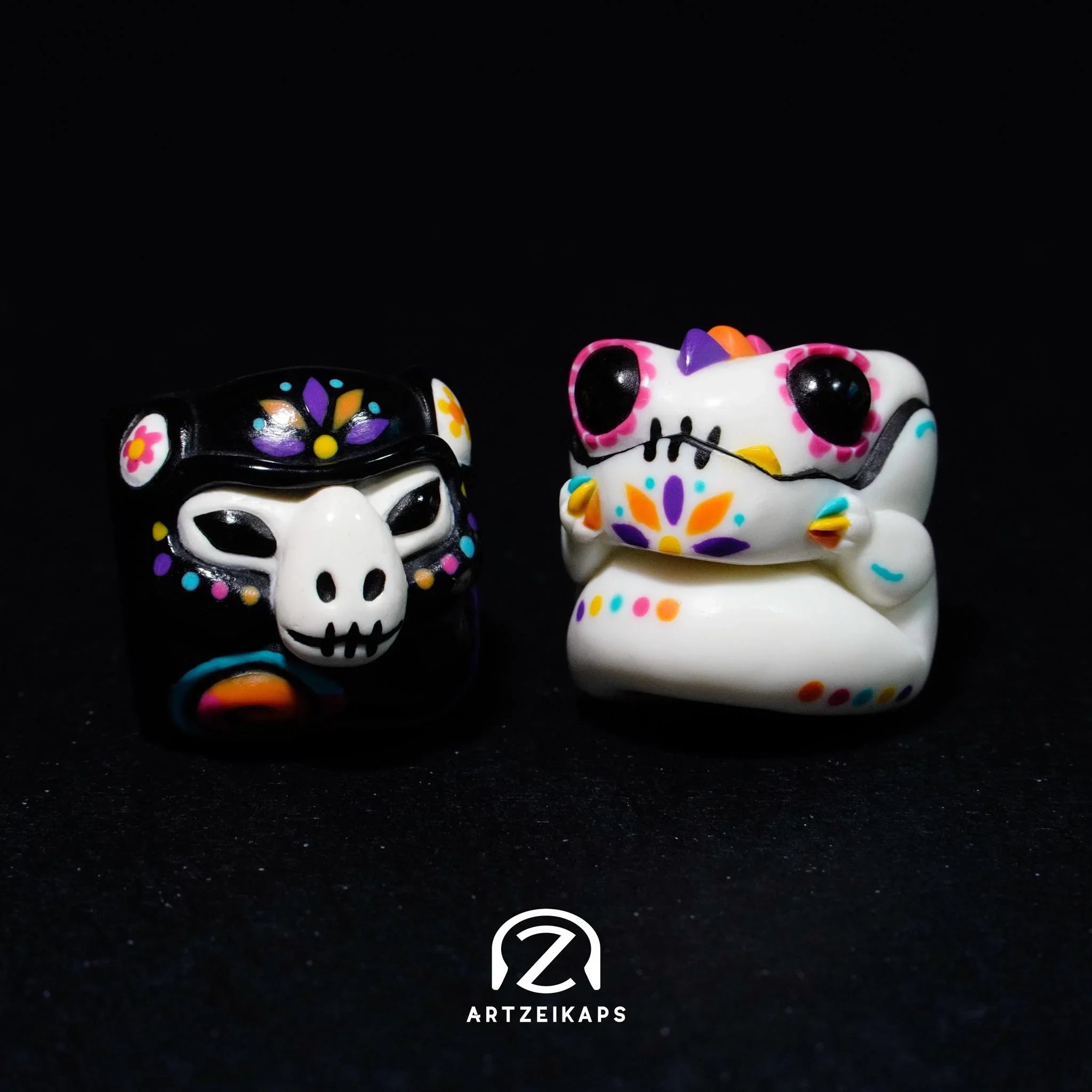Smunkey and Chomper GMK Mictlan artisan keycap pair showing light and dark colourways on dark background