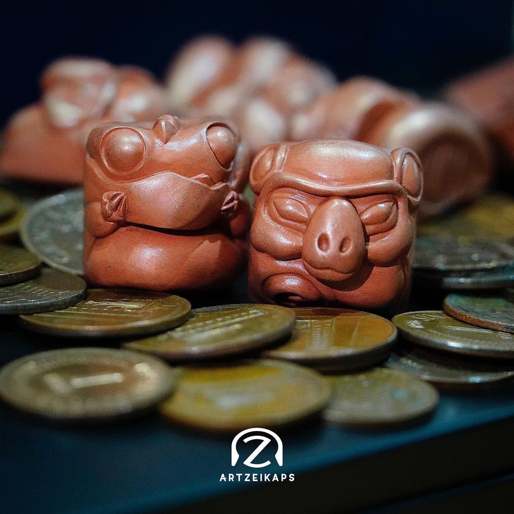 Smunkey artisan keycap in Copper finish with coins, close-up side view