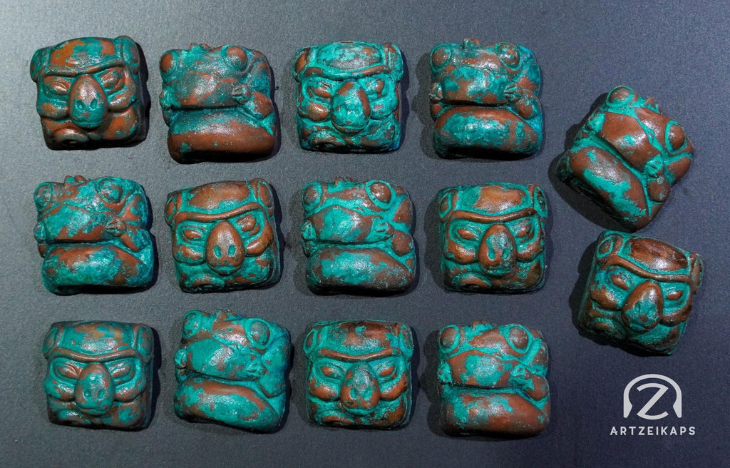 Smunkey and Chomper artisan keycaps in Copper Patina finish, flat lay on dark background