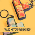 Two handmade Jesmonite WASD keycap keychains showing marbled and layered techniques at Artzei Studio workshop Singapore