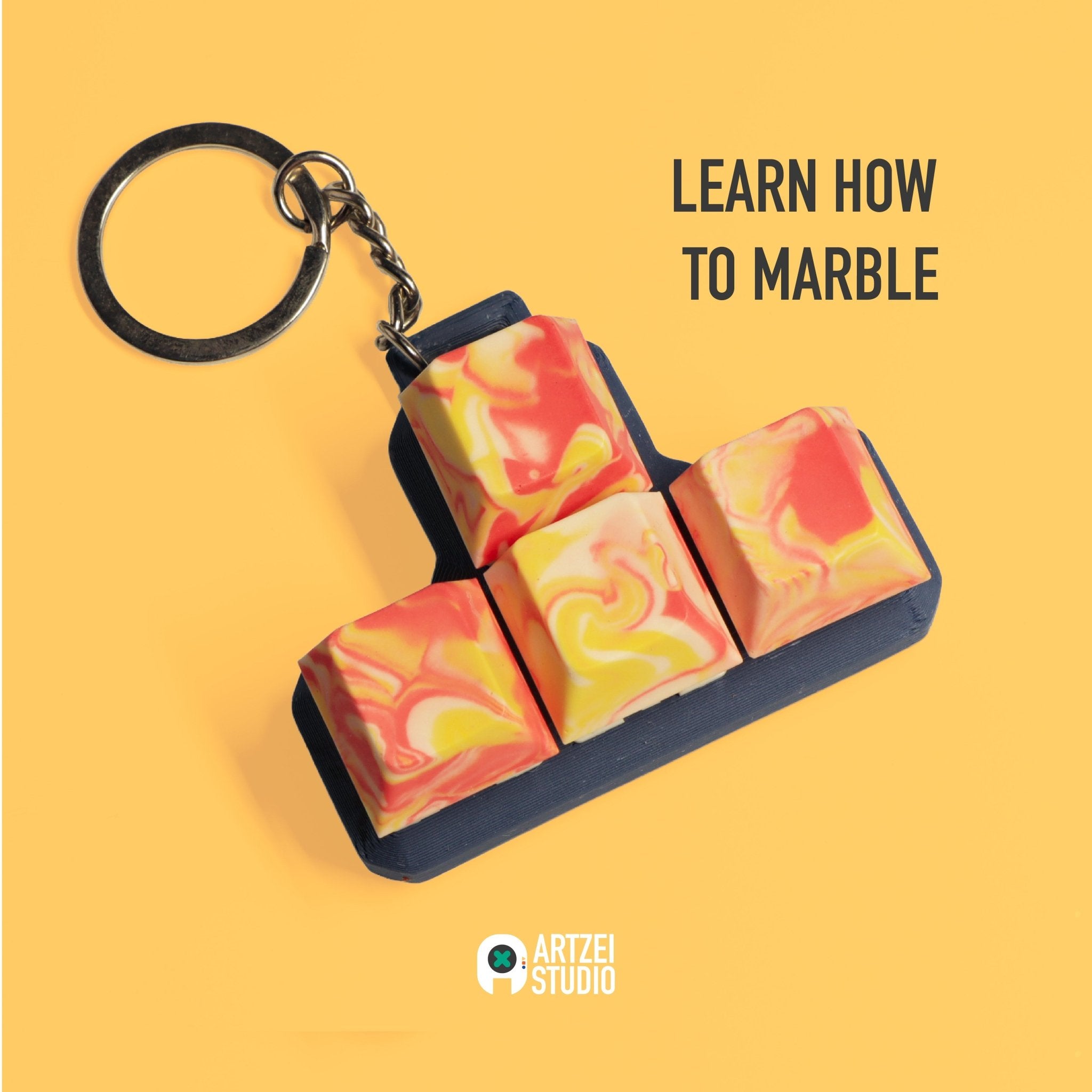 Close-up of handmade Jesmonite WASD keycap set keychain with red and yellow marble pattern by Artzei Studio