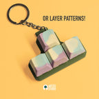 Handmade Jesmonite WASD keycap set keychain with layered pastel pattern made at Artzei Studio workshop