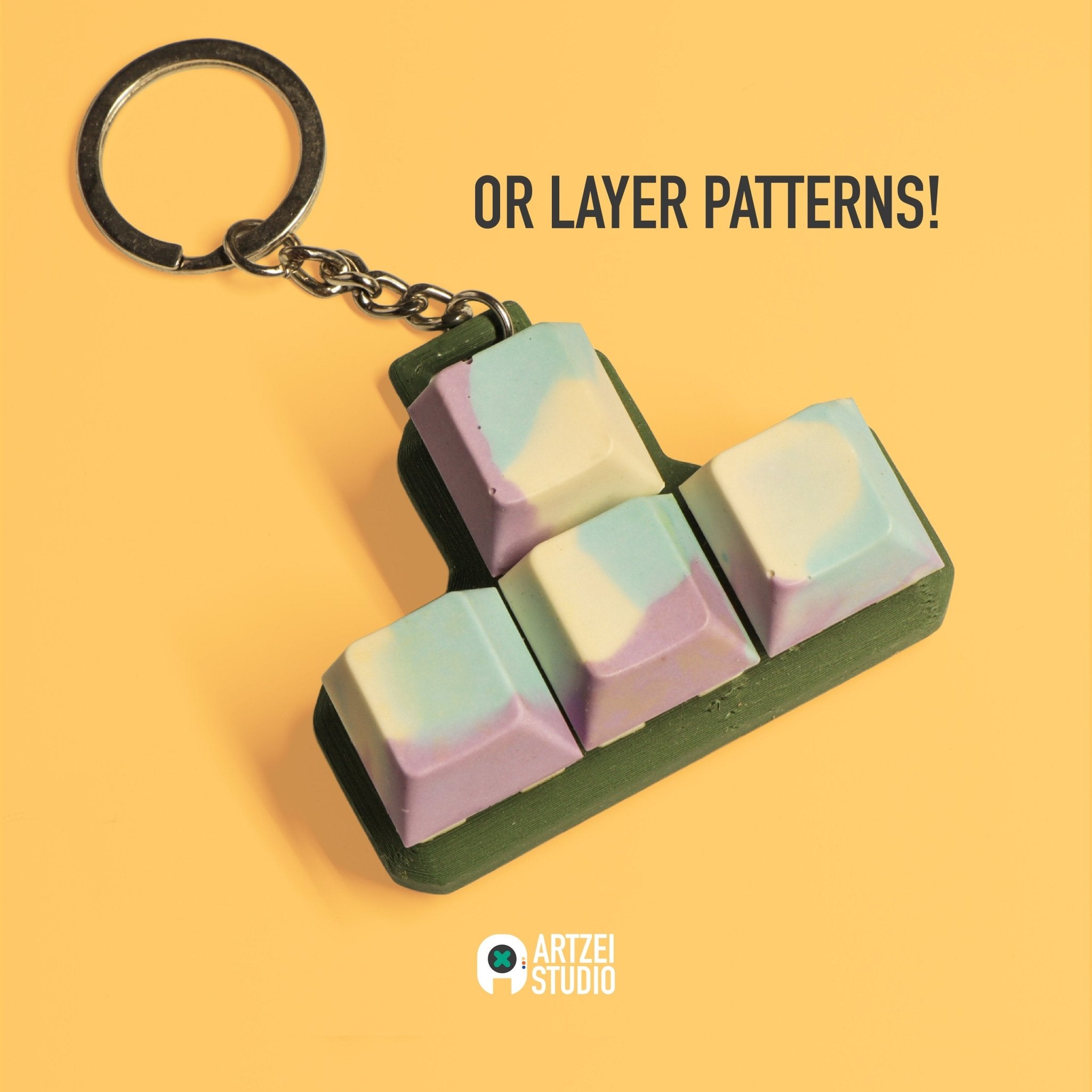 Handmade Jesmonite WASD keycap set keychain with layered pastel pattern made at Artzei Studio workshop